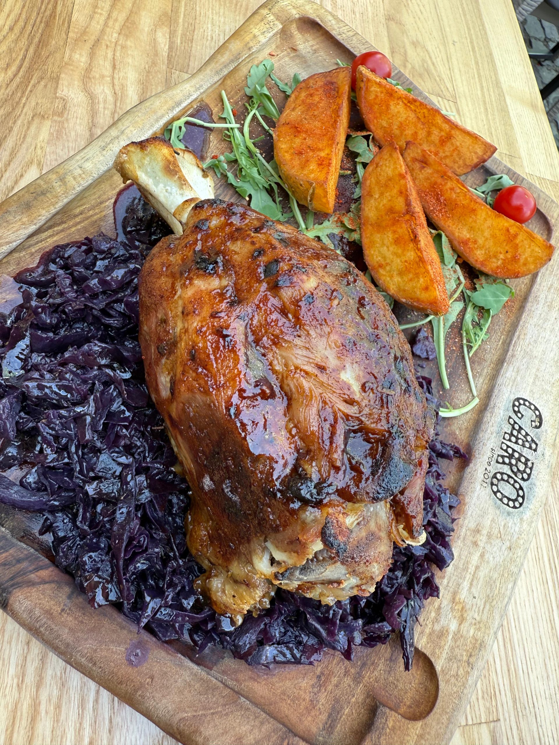 PORK KNUCKLE AND BAKED POTATOES, SEASONED RED CABBAGE